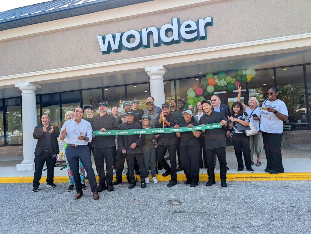 Esther Wells at a ribbon-cutting with local business owners and staff