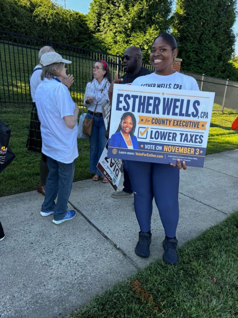 Esther Wells walking in a community parade with supporters